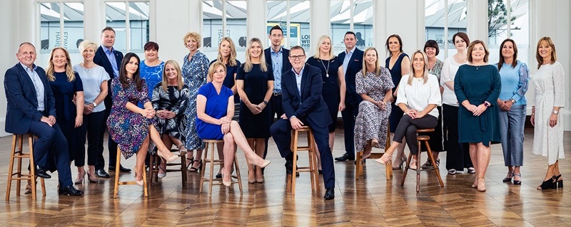 Photo of World Standard Finance Bank team celebrating.